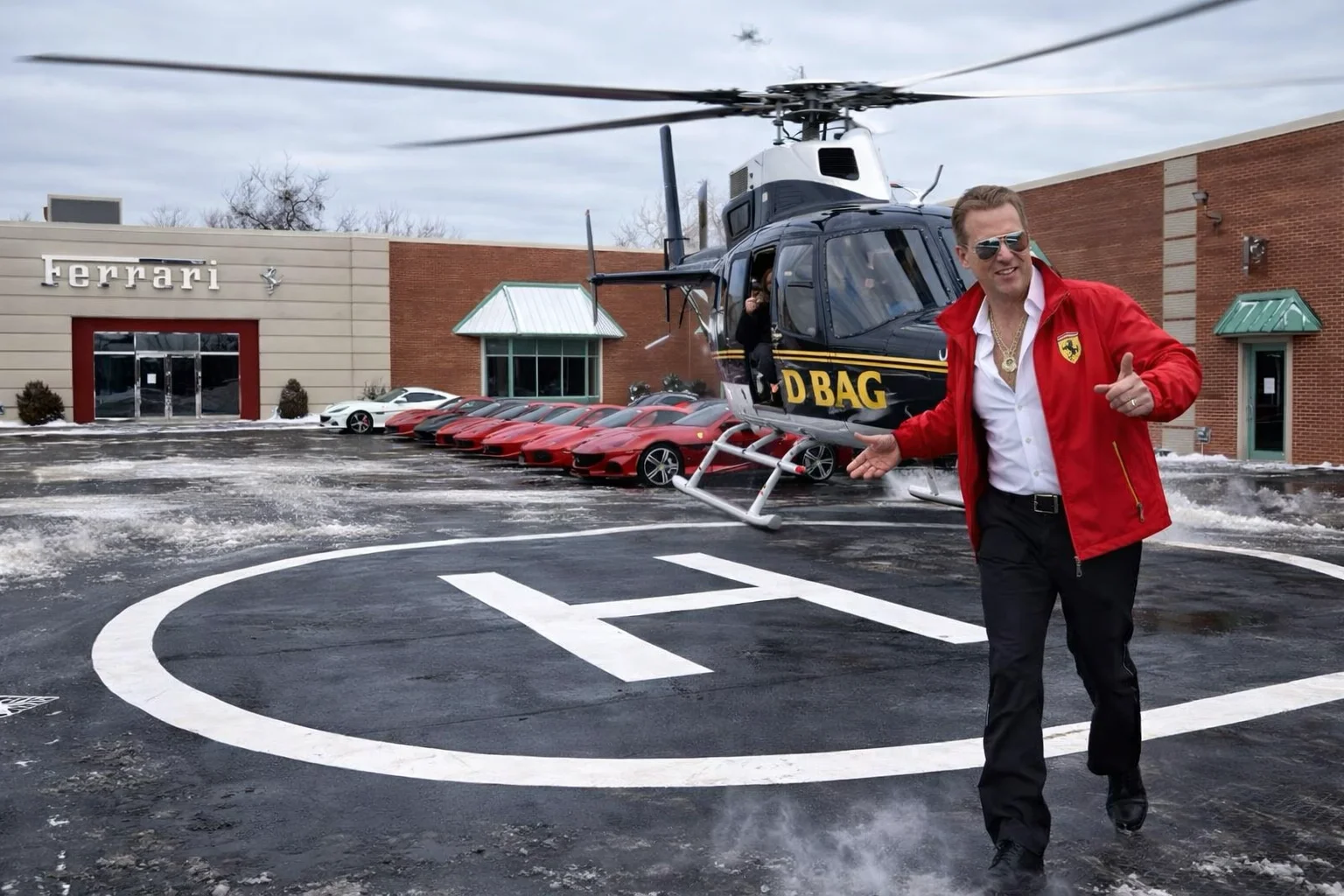 Man in Ferrari jacket stepping off a helicopter on a helipad at the Ferrari dealership